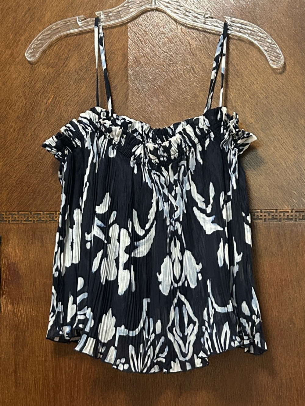 Navy blue printed top with accordion pleating throughout. Adjustable straps.